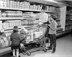 Selecting Clover Dairy products from the dairy case, Sonoma County, California, 1968