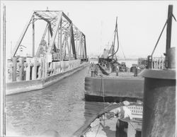 Barges passing through open Northwestern Pacific Railroad bridge on the Petaluma River at Haystack Landing, near Petaluma, California