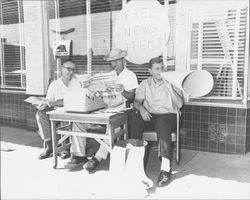 Argus-Courier employees outside the Keller Street office under a sign--Free news items, Petaluma, California, 1962