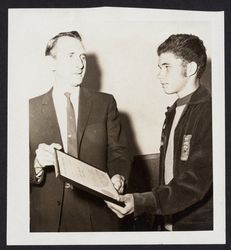 Laren Fregault presenting a plaque to a young Future Farmer of America