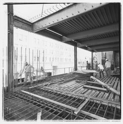 Construction worker pumping concrete into forms for the second floor in the new Exchange Bank building, 545 Fourth Street, Santa Rosa, California, 1971
