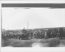 Large group of automobiles and people near the train station in Petaluma, California, about 1910