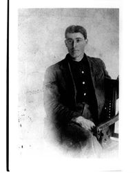 Studio portrait of an unidentified young man of Petaluma, California, seated in a chair, 1880s?