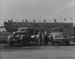 Two unidentified men in the car lot at Spence Peoples Motor Company, Petaluma, California, 1955