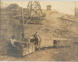 Two men and an electric railroad car at an unidentified Northern California mining Camp, about 1915