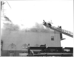 Extinguishing the fire at the California Theatre, Petaluma, California, 1957