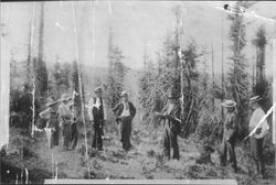 Group watching John Speckter use forks of hazelnut to locate underground stream of water