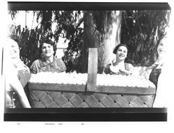 Four women with large basket of eggs, Petaluma, California, about 1930