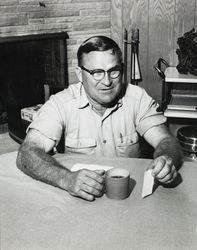 Jack W. Dei, Sr. seated at a table in his Sebastopol home, about 1960