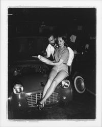 Diane Romero, Miss Sonoma County posing atop a foreign sports car for S.C.C.A. race publicity, Santa Rosa, California, 1957