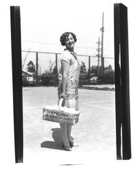 Woman carrying basket of eggs, Petaluma, California, about 1930