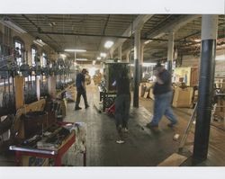 Tim Rhodes checks a machine loaded onto a pallet jack pushed by Juan Rodriguez, Sunset Line & Twine Company in Petaluma, California, Dec. 2006