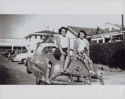 Unidentified girls on a sedan in downtown Petaluma, Oak Street, Petaluma, California, about 1952