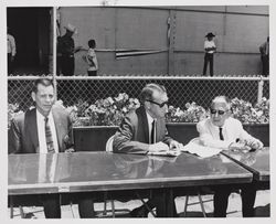 Three men at a table at the Sonoma County Fair, Santa Rosa, California