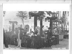 Luther Burbank exhibit at the 1912 Gravenstein Apple Show with Burbank holding a spineless cactus on his shoulder