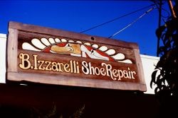 Wooden hand-painted sign of B. Izzarelli Shoe Repair shop, 1977
