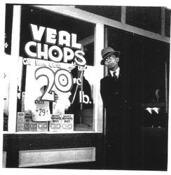 Sign painter Mark Dunn outside Paul's Market, Graton, 1930s