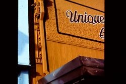 Cast iron column of the Unique Boutique at 150 North Main Street, Sebastopol, California, partially covered by the drain spout
