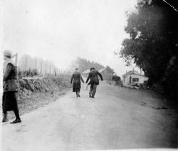 Unidentified people next to a hops field