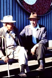 Two unidentified older men sit on a bench outside Safeway at 218 North Main Street, Sebastopol, California, about early 1970s