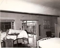 Patient in bed at Old Palm Drive Hospital in a room adjacent to Solarium