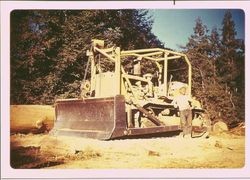 Harry Welsh standing next to D7 Cat, about 1951