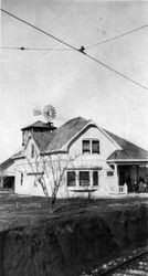 Unidentified house with railroad track in foreground