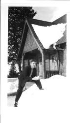 George F. Streckfus standing in a deep snow in front of a chalet-style house, March 5, 1941