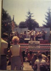 Bandstand at Ives Park in Sebastopol with an audience in front and nine musicians on stage for the "First Annual Kelly Kirksey Old Time Fiddle Championship"