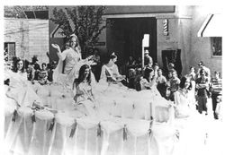 Apple Blossom Queen Kathy Hug on a parade float with her attendants, about 1968