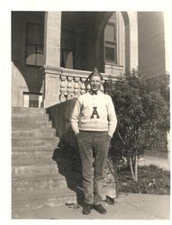 Analy Union High School male cheer leader standing in front of Analy High School, 1920s