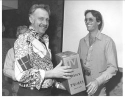 Peter Fonds presenting a TV to an unidentified man during a movie promotion, about 1960s