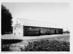West gable end and south facade of the Petaluma & Santa Rosa Railway Powerhouse built 1903 from Stony Point Quarry rock, June 15, 1990