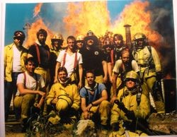 Graton Volunteer Fire Department, about 1987, stand in front of a blazing fire