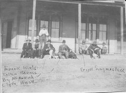 Group of Graton men showing off their dogs on the steps of the hotel in downtown Graton in 1908