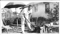 George F. Streckfus in his backyard at make-shift brick barbeque, July 8, 1940