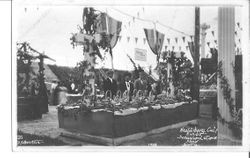 1910 Gravenstein Apple Show display of a building or church made of whole and dried apples with "Forestville" above doorway