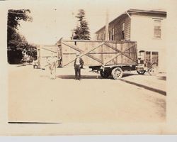 Plane in crate sitting on a truck for delivery