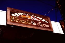 Wooden hand-painted sign of B. Izzarelli Shoe Repair shop, 1977