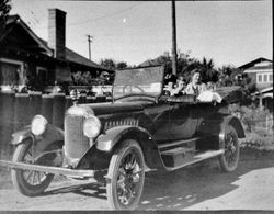 Two ladies and two young children seated in the back of a vintage car, 1920s