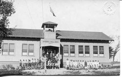 New two-room Spring Hill school building, about 1914, with students and teachers in front of the school