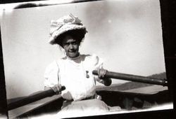 Woman with fancy hat and white dress in boat rowing on Lake Jonive, Sebastopol