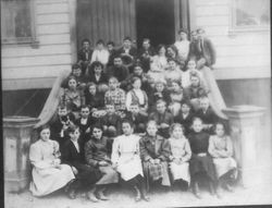 Class of students, boys, girls seated in front of Sebastopol Grammar School, about mid 1900s