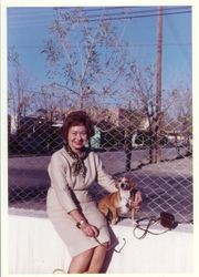 Bunni Cornelia Myers at 59 years old seated on stucco wall with a small dog, about April 1965