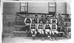 Unidentified members of Analy High School basketball team in 1924 seated on wooden bleacher