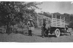 Morris Whitham and Ken loading apples in a vintage 1920s truck at the Whitham's Windsor Ranch