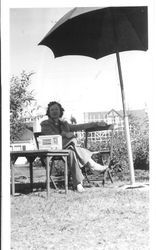 Bunni Cornelia E. Myers Streckfus seated under an umbrella, July 1940