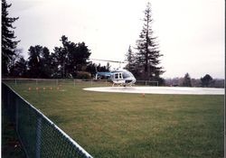 Helicopter landing at Palm Drive Hospital's landing pad, about 1980