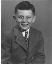 Robert Bulman as a child, dressed in a suit and tie