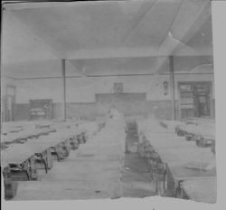 Edna Purrington teacher sitting in an empty school rooms school room, about 1920